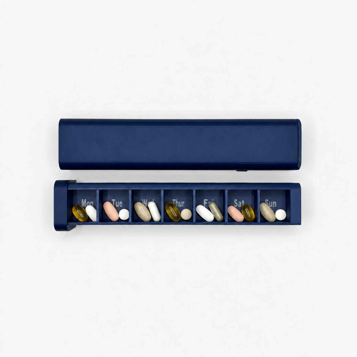 Navy 7-day pill organizer with seven Monday through Sunday compartments shown open